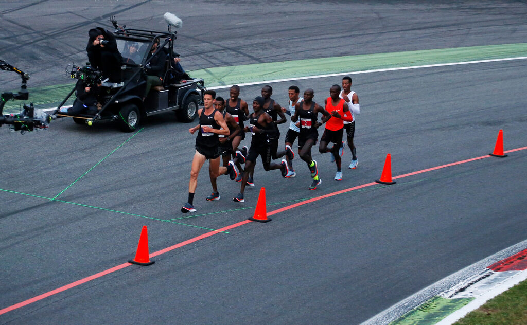 Athletes run during an attempt to break the two-hour marathon barrier at the Monza circuit.