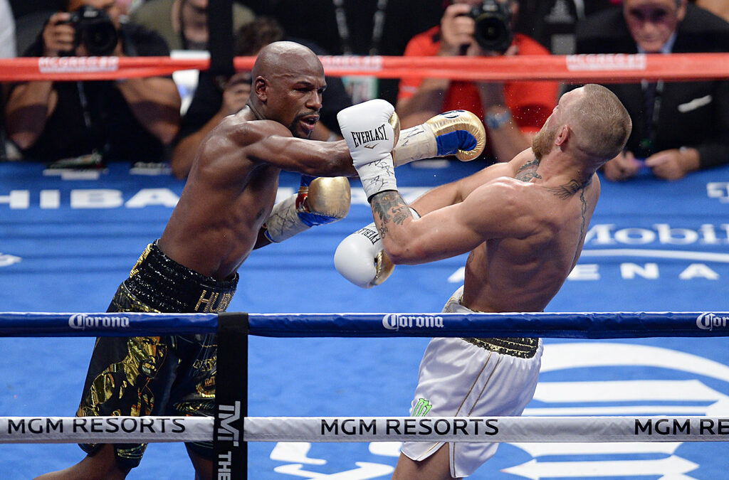 Aug 26, 2017; Las Vegas, NV, USA; Floyd Mayweather Jr. (black trunks) and Conor McGregor (white trunks) box during the ninth round of their boxing match at T-Mobile Arena. Mandatory Credit: Joe Camporeale-USA TODAY Sports