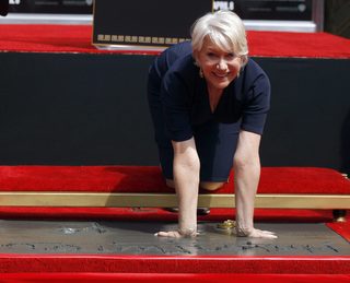 Actress Helen Mirren poses as she makes hand and footprints outside Grauman's Chinese Theatre in Hollywood