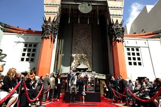 Helen Mirren poses with Russell Brand after making hand and footprints outside Grauman's Chinese Theatre in Hollywood