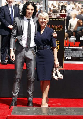 Helen Mirren poses with Russell Brand after making hand and footprints outside Grauman's Chinese Theatre in Hollywood
