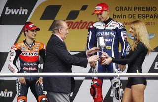 Spanish King Carlos presents the trophy to first-placed Yamaha Lorenzo as second-placed Honda's rider Pedrosa watches during the Spanish Grand Prix in Jerez