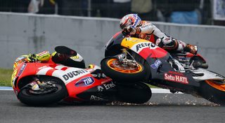 Honda's MotoGP rider Stoner and Ducati's Rossi crash during the Spanish Grand Prix in Jerez