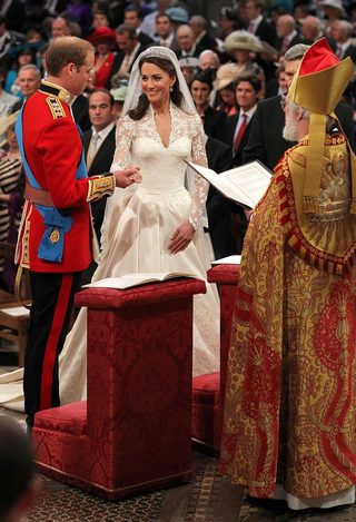 Britain's Prince William, and Kate Middleton stand before the Archbishop of Canterbury, Rowan Williams, during their wedding ceremony In Westminster Abbey, in central London