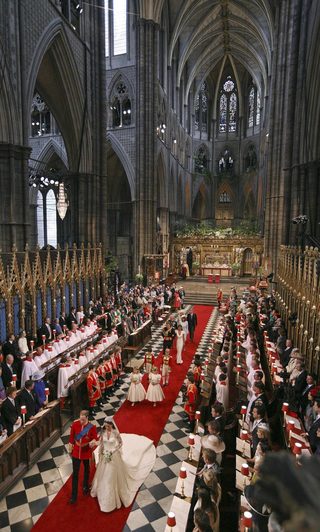 Britain's Prince William and his wife Catherine, Duchess of Cambridge, walk up the aisle after their wedding ceremony in Westminster Abbey, in central London
