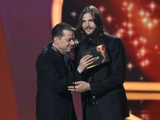 Jon Cryer and Ashton Kutcher from "Two and a Half Men" present the outstanding writing in a drama series award at the 63rd Primetime Emmy Awards in Los Angeles