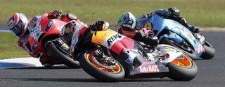 Honda MotoGP rider Pedrosa of Spain rides in front of Ducati MotoGP rider Hayden of US and Suzuki MotoGP rider Bautista of Spain on Phillip Island