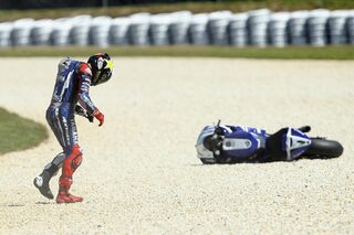 Former MotoGP champion Lorenzo of Spain reacts after crashing during the warm-up session of the Australian Grand Prix on Phillip Island