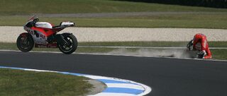 Ducati MotoGP rider Cudlin of Australia crashes during the third practice session of the Australian Grand Prix on Phillip Island near Melbourne