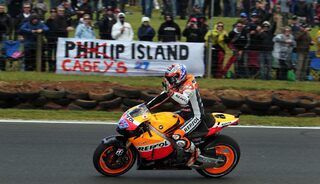 Honda MotoGP rider Stoner of Australia greets the crowd after taking pole position during qualifying session of Australian Grand Prix on Phillip Island near Melbourne