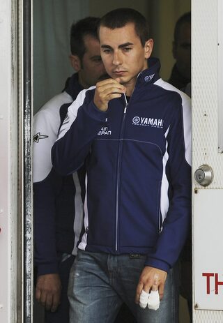 Yamaha MotoGP rider Lorenzo of Spain leaves the first aid services after being treated of his finger injury after crashing during the warm up session of the Australian Grand Prix on Phillip Island near Melbourne