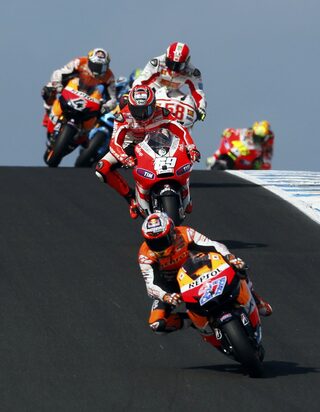 Honda MotoGP rider Casey Stoner of Australia leads the pack during the first lap of the Australian Grand Prix on Phillip Island near Melbourne