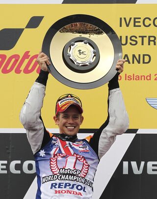Honda MotoGP rider Casey Stoner of Australia celebrates with his trophy after winning the Australian Grand Prix on Phillip Island