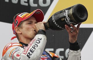 Honda MotoGP rider Casey Stoner of Australia drinks his champagne after winning the Australian Grand Prix on Phillip Island
