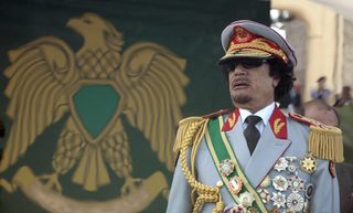 File photo of Libya's leader Gaddafi attending a celebration of the 40th anniversary of his coming to power in Tripoli