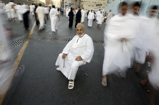 A Muslim pilgrim sits on the road after prayers at the Grand Mosque during the annual haj pilgrimage in Mecca
