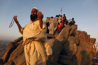 A Muslim pilgrim prays atop Mount Al-Noor during the annual haj pilgrimage in Mecca