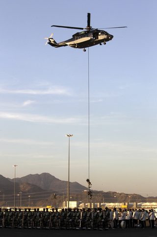 Members of the Saudi security forces perform during a military parade in preparation for the annual haj pilgrimage in Mecca