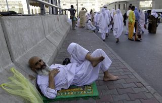 A Muslim pilgrim lies on the road after prayers at the Grand Mosque during the annual haj pilgrimage in Mecca