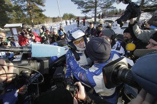 Finland's Jari-Matti Latvala and his co-driver Miika Anttila are surrounded by the media next to their Ford Fiesta RS WRC after winning the WRC Rally of Sweden in Hagfors
