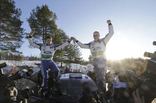 Finland's Jari-Matti Latvala (R) and his co-driver Miika Anttila stand on their Ford Fiesta RS WRC as they celebrate winning the WRC Rally of Sweden in Hagfors