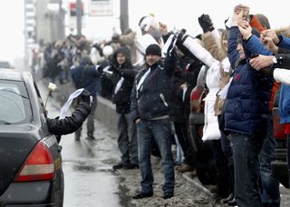 Opposition supporters take part in a protest rally called The White Ring by forming a human chain along the Garden Ring road in Moscow