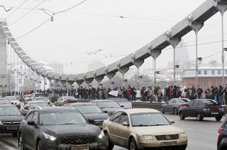 Opposition supporters take part in a protest rally called The White Ring by forming a human chain along the Garden Ring road in Moscow