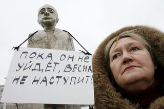 A woman holds a dummy depicting Russian Prime Minister Vladimir Putin during an opposition rally in Russian southern city of Rostov-on-Don