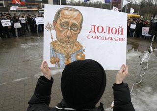 A man holds a caricature of Russian Prime Minister Vladimir Putin during an opposition rally in Russian southern city of Rostov-on-Don