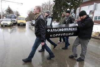 People carry a fake coffin during an opposition rally demanding a fair election in the southern Russian city of Stavropol