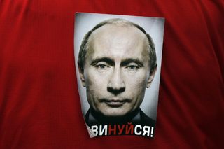 A participant wears a sticker with the word "Obey!" during an opposition protest on Revolution square in central Moscow