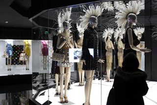 A visitor looks at fashion creations during the press presentation of the 'Louis Vuitton - Marc Jacobs: The Exhibition' at the Museem of Decorative Arts in Paris