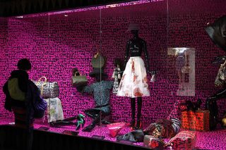 A visitor looks at fashion creations during the press presentation of the 'Louis Vuitton - Marc Jacobs: The Exhibition' at the Museem of Decorative Arts in Paris