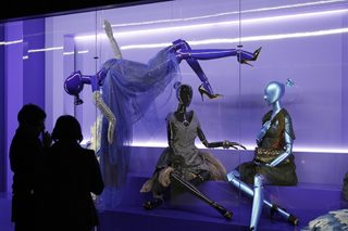 Visitors look at fashion creations during the press presentation of the 'Louis Vuitton - Marc Jacobs: The Exhibition' at the Museem of Decorative Arts in Paris