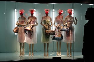 A visitor looks at fashion creations during the press presentation of the 'Louis Vuitton - Marc Jacobs: The Exhibition' at the Museem of Decorative Arts in Paris