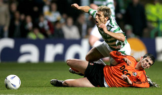 Celtic's Stilian Petrov is brought down by Shakhtar Donetsk's Cosmin Barcauan during their Champions League Group F match in Glasgow