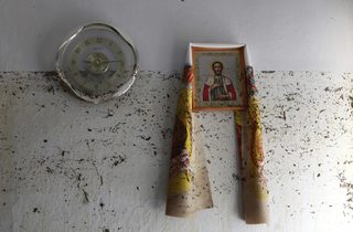 An icon hangs on the wall, with dirt from the floods marked on it, in the town of Krymsk in Krasnodar region