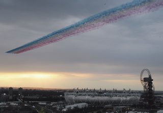 The Red Arrows fly across the Olympic Park in Stratford, east London ahead of the opening ceremony of the 2012 Olympic Games