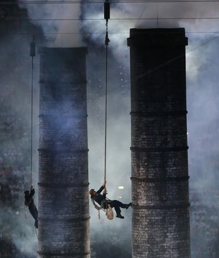 Performers take part in the opening ceremony of the London 2012 Olympic Games at the Olympic Stadium