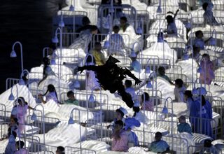 A man dressed as a goblin descends on the children during a performance at the London 2012 Olympic Games