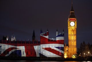 The Union Flag, commonly known as the Union Jack, is projected on the Palace of Westminster next to Big Ben on the bank of the River Thames, before the London 2012 Olympic Games