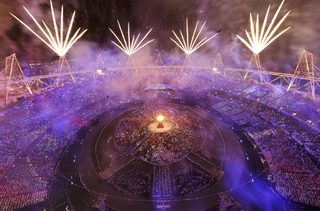Fireworks explode over the lit Olympic Cauldron during the opening ceremony of the London 2012 Olympic Games at the Olympic Stadium