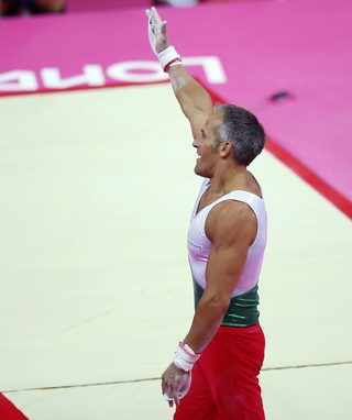 Jordan Jovtchev of Bulgaria gestures as he receives applause from the crowd after competing in the rings in London