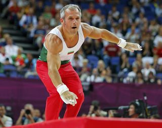 Bulgaria's Jordan Jovtchev stumbles on his landing as he competes in the men's gymnastics rings final in the North Greenwich Arena during the London 2012 Olympic Games