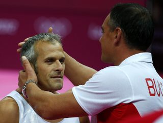 Bulgaria's Jordan Jovtchev is seen with his coach at the men's gymnastics rings final in the North Greenwich Arena during the London 2012 Olympic Games