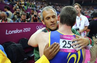 Brazil's Arthur Nabarrete Zanetti hugs Bulgaria's Jordan Jovtchev as he celebrates winning a gold medal in the men's gymnastics rings final in the North Greenwich Arena