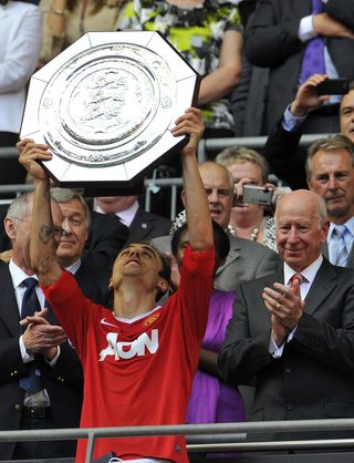 Manchester United's Berbatov lifts the English Community Shield trophy after defeating Chelsea during their soccer match in London