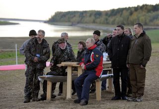 Russian President Vladimir Putin meets with ornithologists after a flight in a motorized deltaplane at Yamalo-Nenets district