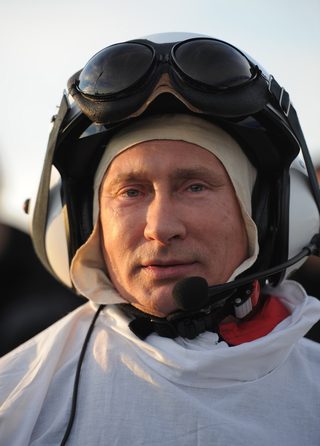 Russian President Vladimir Putin walks after a flight in a motorized deltaplane at Yamalo-Nenets district