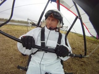 Russian President Vladimir Putin sits in a motorised deltaplane at Yamalo-Nenets district